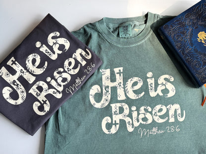 He is Risen Easter Comfort Colors Tee, Beige on Graphite/Blue Spruce