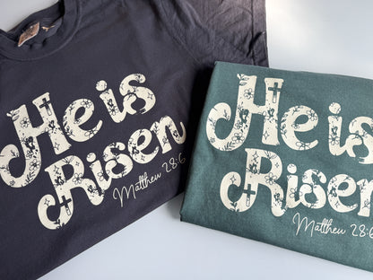 He is Risen Easter Comfort Colors Tee, Beige on Graphite/Blue Spruce